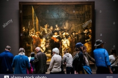 visitors-watching-the-night-watch-rembrandts-largest-and-most-famous-painting-in-rijksmuseums-gallery-MBCEBC